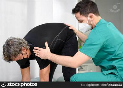 Physiotherapist helping patient in clinic. High quality photo. Physiotherapist helping patient in clinic.