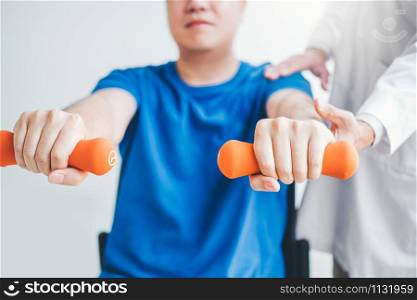 Physiotherapist man giving exercise with dumbbell treatment About Arm and Shoulder of athlete male patient Physical therapy concept