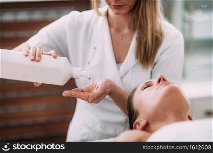 Physiotherapist massaging female patient  