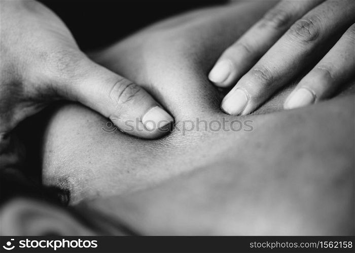 Physiotherapist massaging female patient with injured shoulder blade. Sports injury treatment.. Shoulder blade Sports Massage Therapy