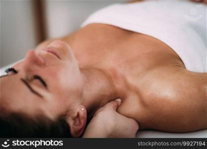 Physiotherapist massaging female patient with injured shoulder blade.  Sports injury treatment.. Shoulder blade Sports Massage Therapy