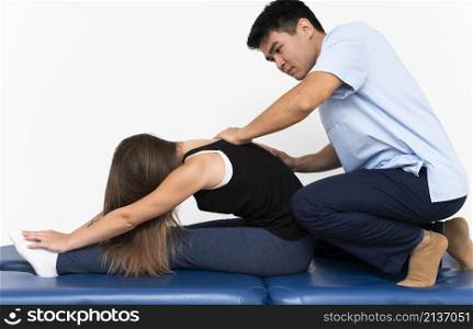 physiotherapist massaging woman s upper back pain