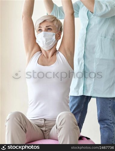 physiotherapist undergoing therapy with female patient 2