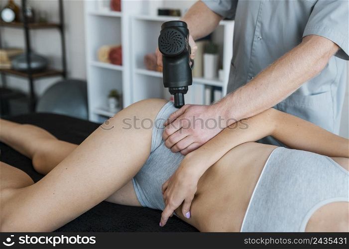 physiotherapist with woman equipment during physical therapy session