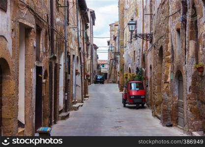 Piaggio Ape standing at the empty street of old italian town