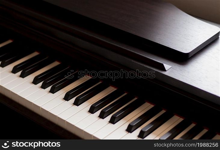 Piano and Electronic piano keyboard with black backgrounds. Closeup of black and white piano keys, copy space, banner