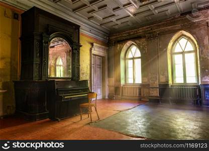 Piano in the hall of abandoned Sharovskiy castle or Sharovka, Kharkov region. Piano in abandoned castle