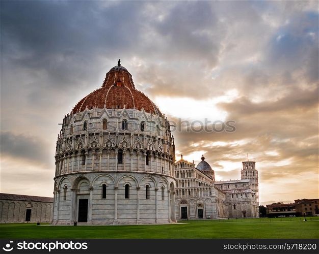 Piazza dei Miracoli; in foreground the Baptistry, the Dome than the leaning tower of Pisa, Italy.