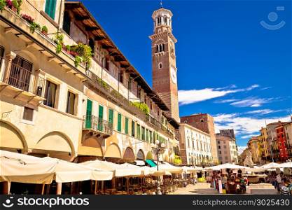 Piazza delle Erbe in Verona street and market view with Lamberti tower, tourist destination in Veneto region of Italy