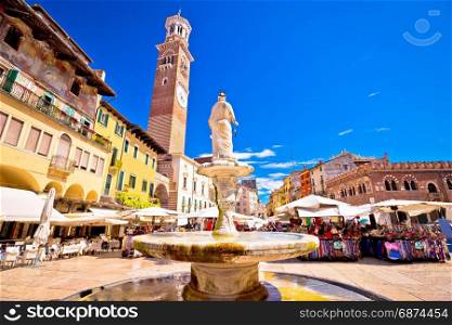 Piazza delle erbe in Verona street and market view with Lamberti tower, tourist destination in Veneto region of Italy