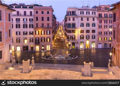 Piazza di Spagna and the Early Baroque fountain called Fontana della Barcaccia or Fountain of the ugly Boat during morning blue hour, Rome, Italy.. Piazza di Spagna at night, Rome, Italy.