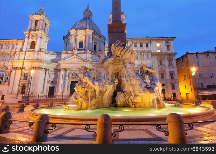 Piazza Navona Square at night, Rome, Italy.. Fountain of the Four Rivers and Sant Agnese Church on the famous Piazza Navona Square during morning blue hour, Rome, Italy.