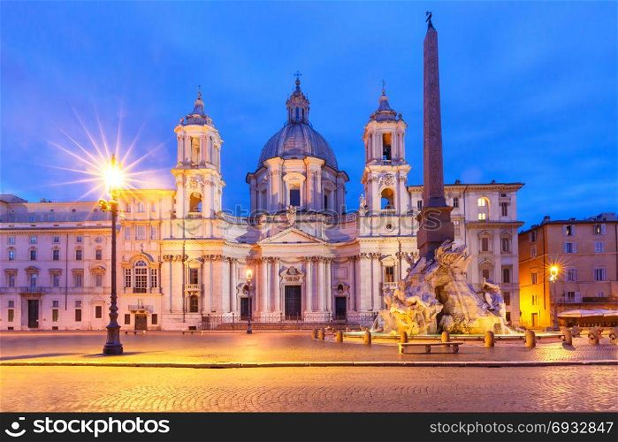 Piazza Navona Square at night, Rome, Italy.. Fountain of the Four Rivers with an Egyptian obelisk and Sant Agnese Church on the famous Piazza Navona Square at night, Rome, Italy.