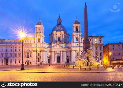 Piazza Navona Square at night, Rome, Italy.. Fountain of the Four Rivers with an Egyptian obelisk and Sant Agnese Church on the famous Piazza Navona Square at night, Rome, Italy.