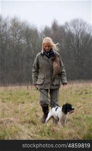 Picker up with her spaniel on a pheasant shoot