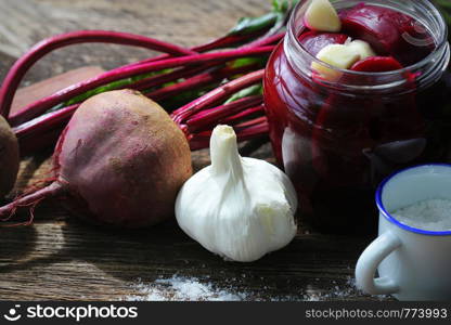 Pickled beets in the jar on a dark wood background .. Pickled beets in the jar on a dark wood background