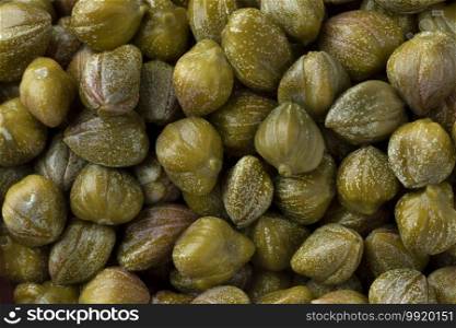 Pickled capers close up full frame as background 