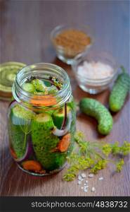 Pickled cucumbers, homemade preserved on wooden table