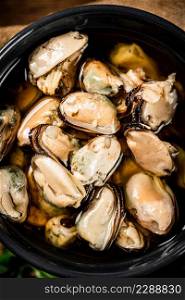 Pickled mussels in a bowl. Macro background. High quality photo. Pickled mussels in a bowl. Macro background.