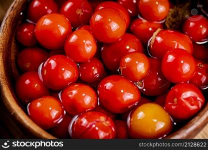 Pickled tomatoes on a plate. Macro background. High quality photo. Pickled tomatoes on a plate. Macro background.