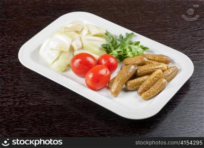 pickled vegetables of tomato, cucumber, cabbage at table