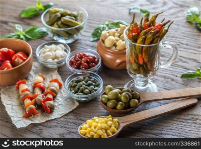 Pickled vegetables on the wooden background