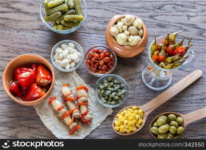 Pickled vegetables on the wooden background