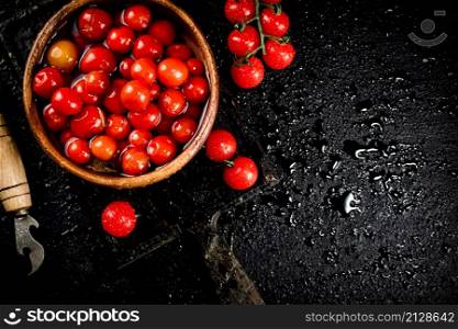Pickling ripe homemade tomatoes on the table. On a black background. High quality photo. Pickling ripe homemade tomatoes on the table.