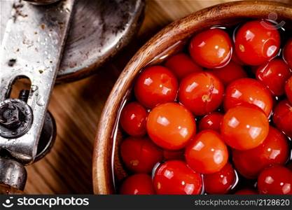 Pickling ripe tomatoes at home. On a wooden background. High quality photo. Pickling ripe tomatoes at home.