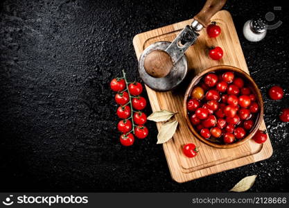 Pickling ripe tomatoes on a cutting board. On a black background. High quality photo. Pickling ripe tomatoes on a cutting board.