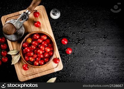 Pickling ripe tomatoes on a cutting board. On a black background. High quality photo. Pickling ripe tomatoes on a cutting board.