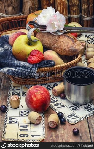 picnic basket with fruit,a blanket,and playing Lotto.