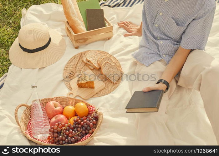 picnic concept The guy with blue and white stripped and short sleeved shirt being on a picnic in the sunny day.