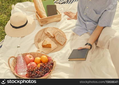 picnic concept The guy with blue and white stripped and short sleeved shirt being on a picnic in the sunny day.