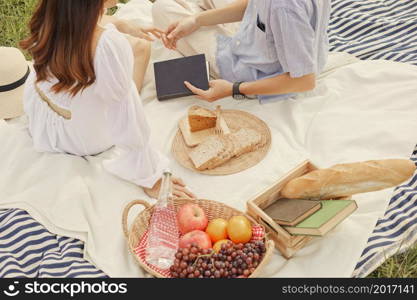 picnic concept The spouse who takes a picnic together sitting on the cloth and trying to hold each other&rsquo;s hand.