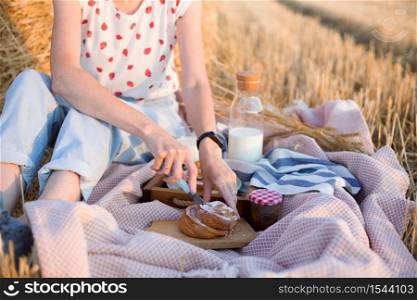 picnic in a wheat field near Round Bales. milk and cinnamon rolls