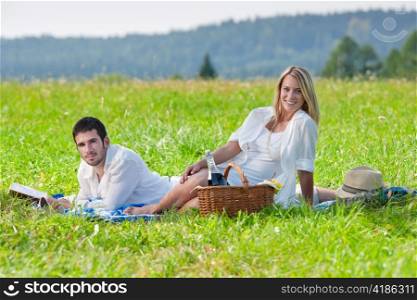 Picnic - Romantic happy couple in meadows nature reading book
