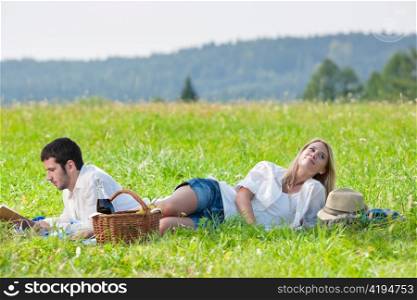 Picnic - Romantic happy couple in meadows nature reading book
