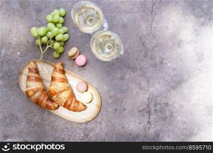 picnic with wine and croissants on concrete table. picnic with wine