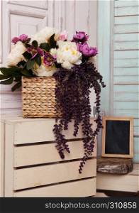 Picture frame and flowers on wooden box.Pink doors,flowers,apple boxes.Great for wedding interior