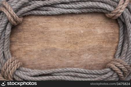 picture frame of rope on a old wooden background