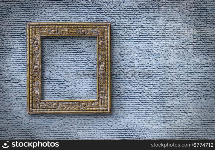 Picture frame on light blue brick wall