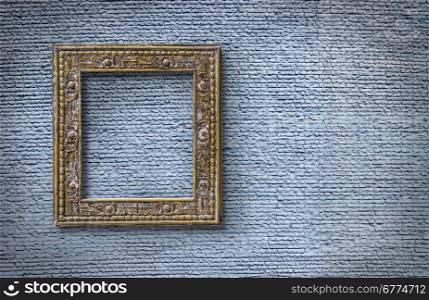 Picture frame on light blue brick wall