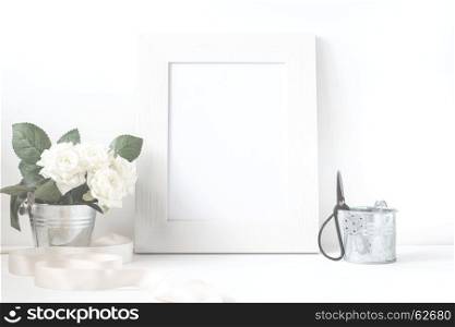 Picture frame with flower bouquet on wooden table.