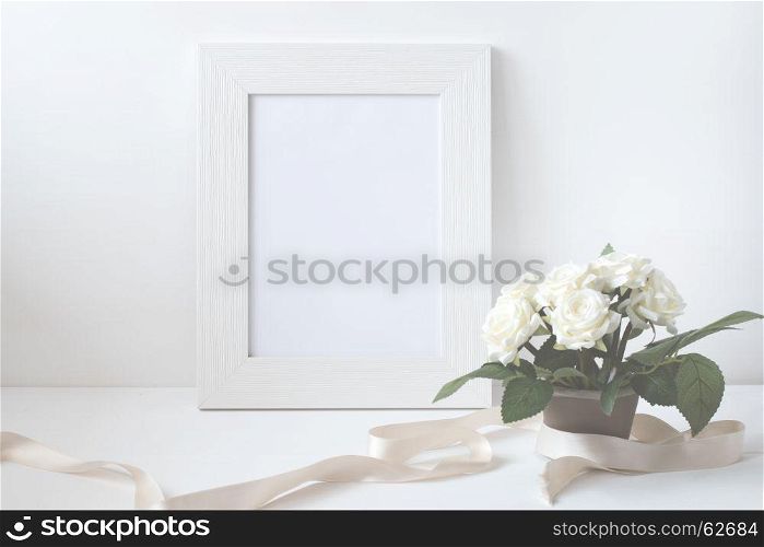 Picture frame with flower bouquet on wooden table.