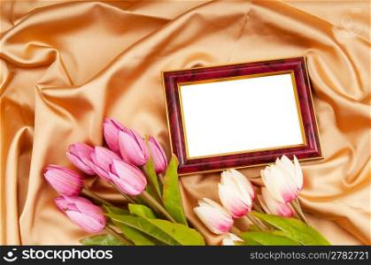 Picture frames and tulips flowers on satin
