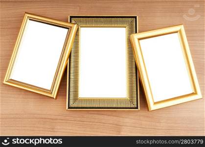 Picture frames on the polished wooden background