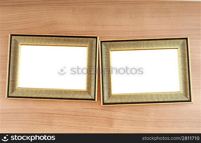 Picture frames on the polished wooden background