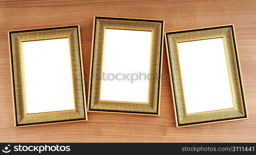 Picture frames on the polished wooden background