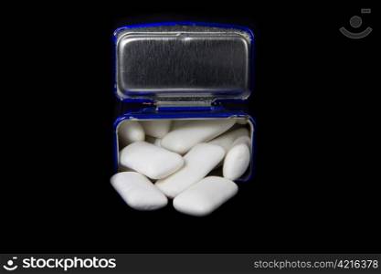 Picture of a blue box with some white gums in it